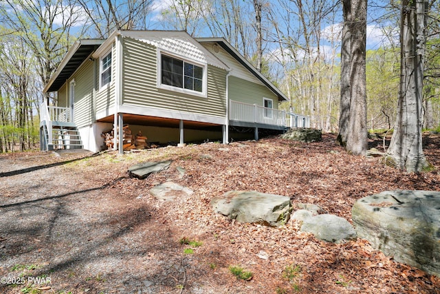 view of side of property with stairway and a deck