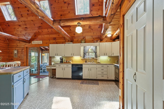 128 Timber Ln, Tafton, PA 18464 - kitchen featuring black dishwasher, a skylight, wooden walls, a sink, and light countertops