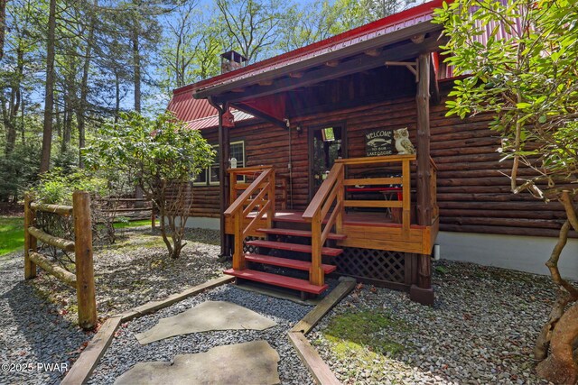 128 Timber Ln, Tafton, PA 18464 - entrance to property with log exterior, metal roof, a deck, and a chimney