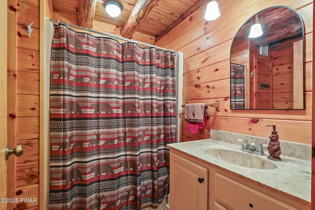 128 Timber Ln, Tafton, PA 18464 - full bathroom featuring wooden ceiling with exposed beams, vanity, curtained shower, and wood walls