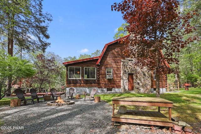 128 Timber Ln, Tafton, PA 18464 - rear view of property with a fire pit, a gambrel roof, log exterior, and a lawn