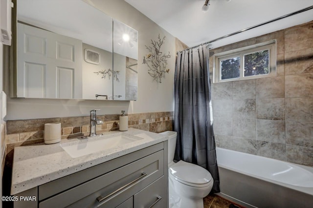 full bathroom featuring vanity, tile walls, shower / tub combo, and toilet