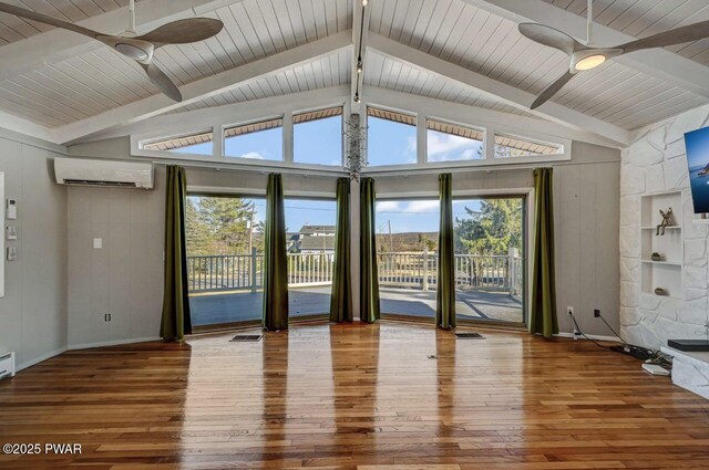 unfurnished living room featuring a wall mounted air conditioner, ceiling fan, and hardwood / wood-style flooring