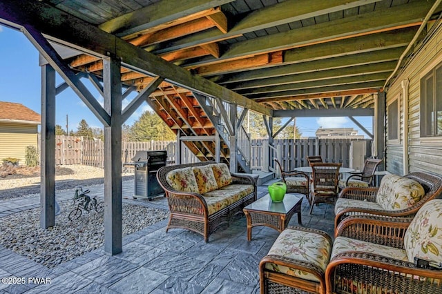 view of patio featuring grilling area, outdoor lounge area, and a fenced backyard