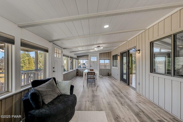 sunroom with lofted ceiling with beams