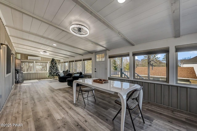 sunroom with lofted ceiling with beams, plenty of natural light, wood ceiling, and a wall unit AC