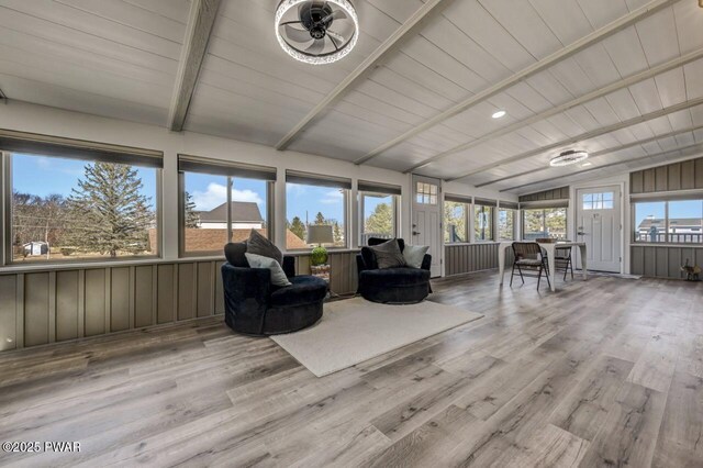 unfurnished sunroom featuring a wealth of natural light, wooden ceiling, and lofted ceiling with beams