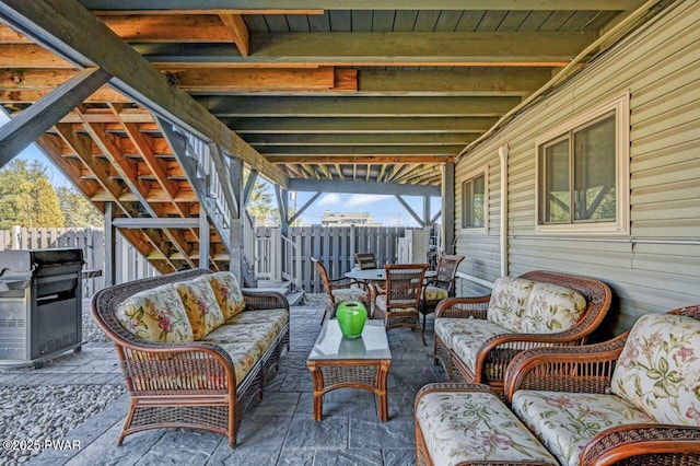 view of patio / terrace featuring area for grilling, outdoor lounge area, and fence