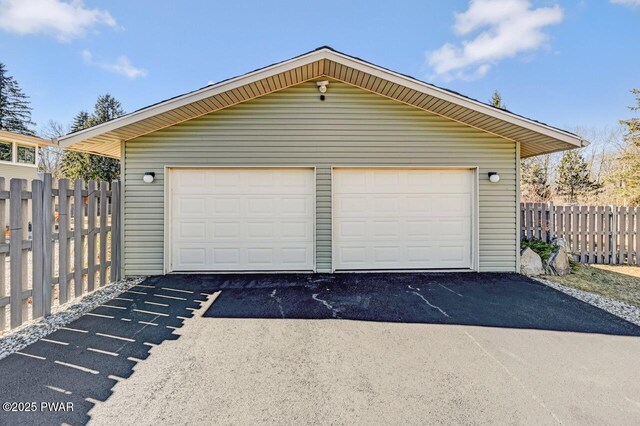 detached garage featuring fence