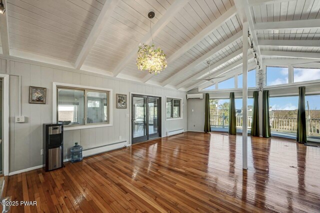 unfurnished living room with an AC wall unit, hardwood / wood-style flooring, lofted ceiling with beams, and baseboard heating