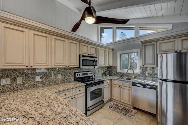 kitchen with a sink, cream cabinets, backsplash, and stainless steel appliances