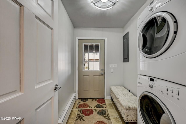 clothes washing area with a baseboard radiator, light tile patterned flooring, and stacked washer / dryer