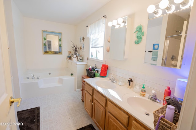 bathroom with a garden tub, double vanity, a sink, and decorative backsplash