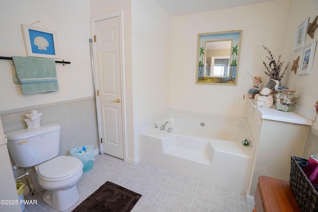 full bathroom with toilet and a garden tub