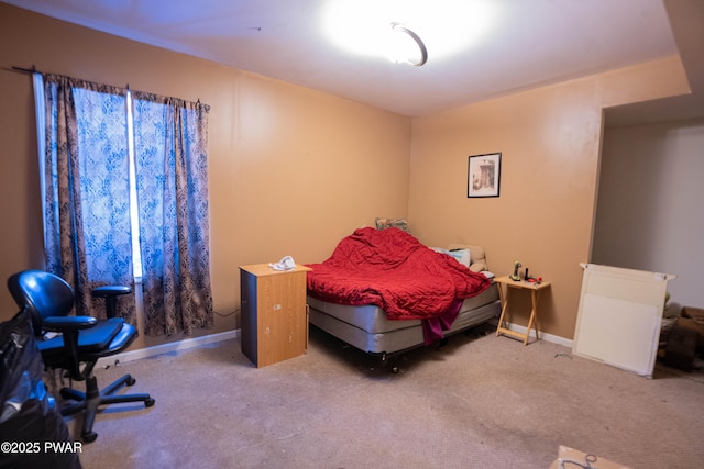 carpeted bedroom featuring baseboards