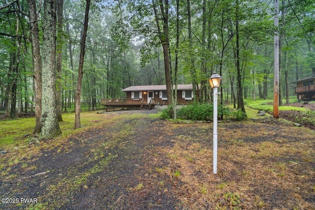 1081 Maple Lake Dr, Bushkill, PA 18324 - view of front of property with a wooden deck and a view of trees