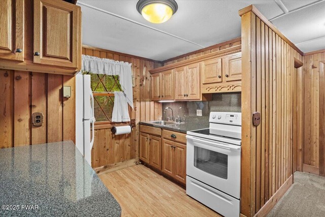 1081 Maple Lake Dr, Bushkill, PA 18324 - kitchen with white appliances, wood walls, light wood-style floors, and tasteful backsplash