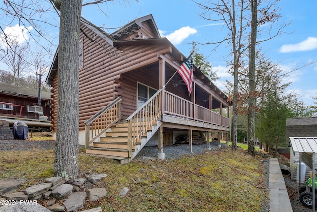 rear view of property with a wooden deck