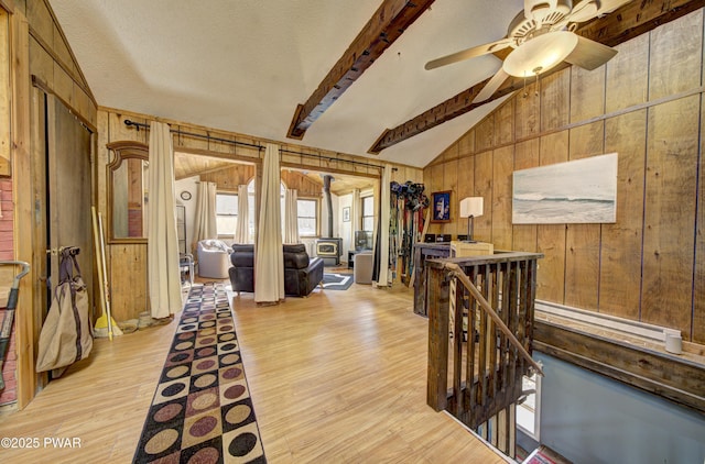 109 Pebble Rock Rd, Lackawaxen, PA 18435 - interior space with an upstairs landing, lofted ceiling with beams, wooden walls, light wood finished floors, and a baseboard radiator