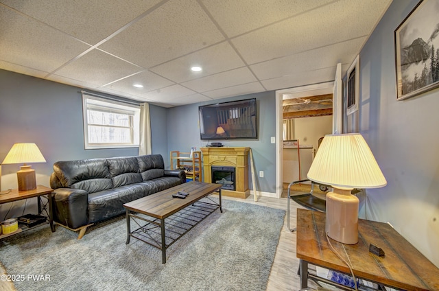 109 Pebble Rock Rd, Lackawaxen, PA 18435 - living area with baseboards, a fireplace, wood finished floors, and a paneled ceiling