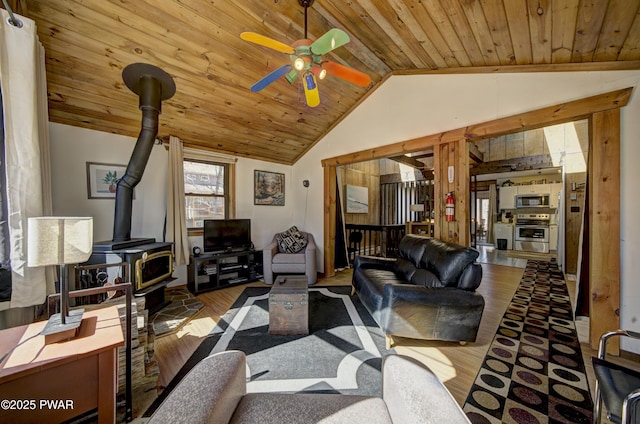 109 Pebble Rock Rd, Lackawaxen, PA 18435 - living area with vaulted ceiling, a wood stove, wood ceiling, a ceiling fan, and wood finished floors