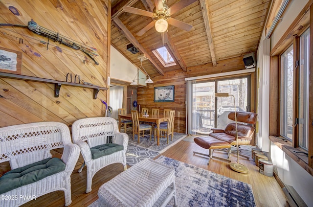 109 Pebble Rock Rd, Lackawaxen, PA 18435 - living room featuring wood walls, a skylight, ceiling fan, beam ceiling, and wooden ceiling