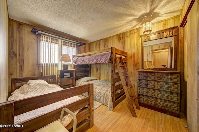 109 Pebble Rock Rd, Lackawaxen, PA 18435 - bedroom featuring wooden walls, wood finished floors, and a textured ceiling