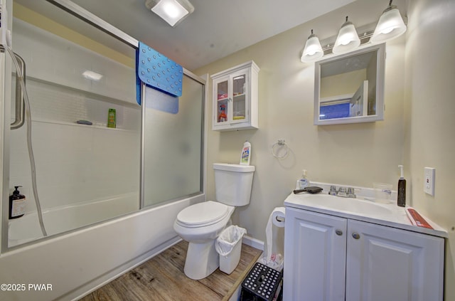 109 Pebble Rock Rd, Lackawaxen, PA 18435 - bathroom featuring toilet, vanity, wood finished floors, baseboards, and shower / bath combination with glass door