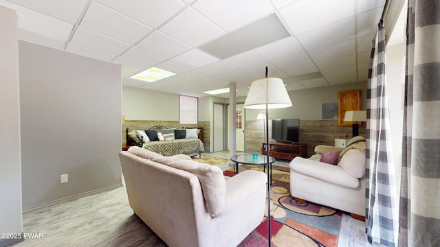 677 W Chipmunk Rd, Bushkill, PA 18324 - living room featuring baseboards, light wood-style floors, and a drop ceiling