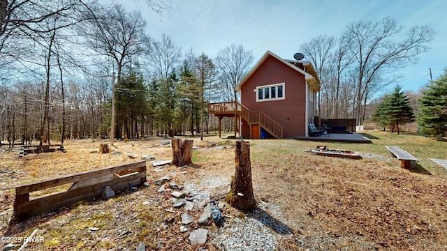 677 W Chipmunk Rd, Bushkill, PA 18324 - view of front of home featuring a chimney, dirt driveway, an attached garage, a wooden deck, and roof with shingles