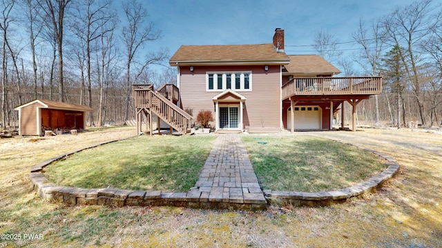 677 W Chipmunk Rd, Bushkill, PA 18324 - rear view of property featuring a chimney, a deck, a yard, a garage, and stairs