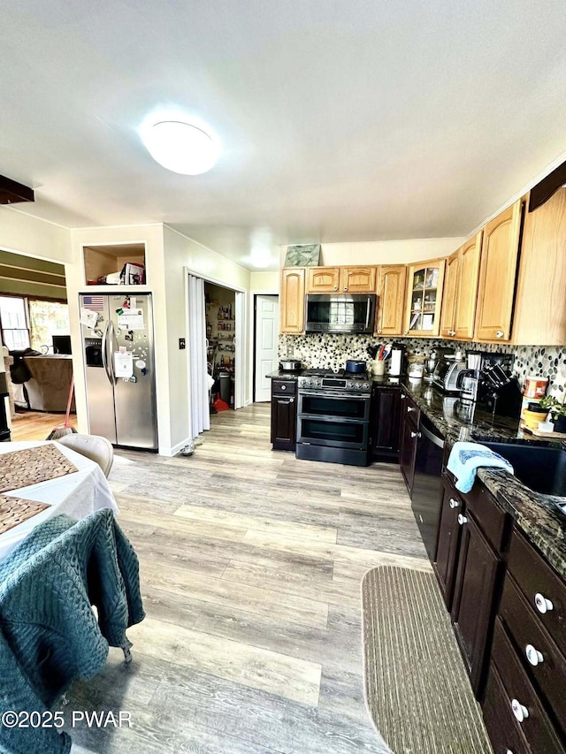 205 Waterview Dr, Lords Valley, PA 18428 - kitchen with stainless steel appliances, tasteful backsplash, a sink, glass insert cabinets, and light wood-style flooring