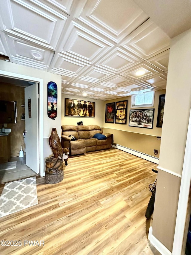205 Waterview Dr, Lords Valley, PA 18428 - living area with a baseboard radiator, wood finished floors, and baseboards