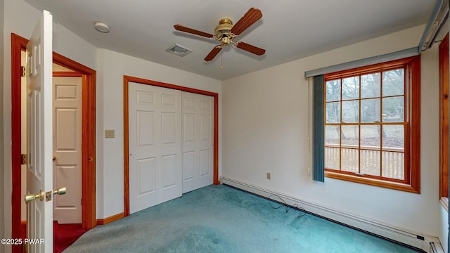 unfurnished bedroom featuring visible vents, a closet, carpet flooring, baseboard heating, and ceiling fan