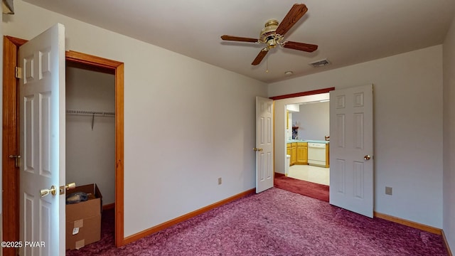 unfurnished bedroom featuring visible vents, carpet floors, baseboards, and a closet