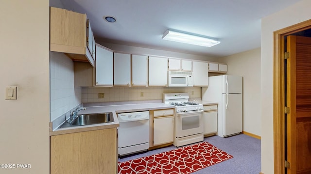 kitchen with a sink, tasteful backsplash, white appliances, carpet flooring, and light countertops