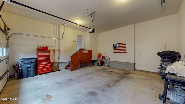 garage featuring visible vents and a garage door opener