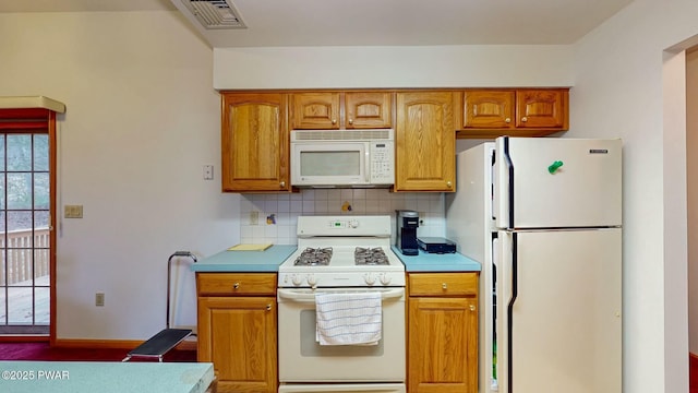 kitchen with white appliances, brown cabinetry, visible vents, decorative backsplash, and light countertops