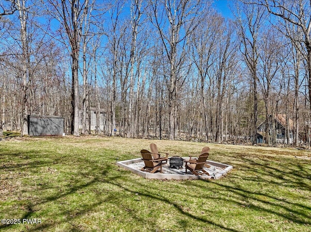 view of yard featuring an outdoor fire pit