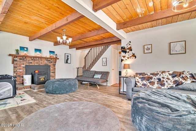 living area with an inviting chandelier, wood ceiling, stairs, and wood finished floors