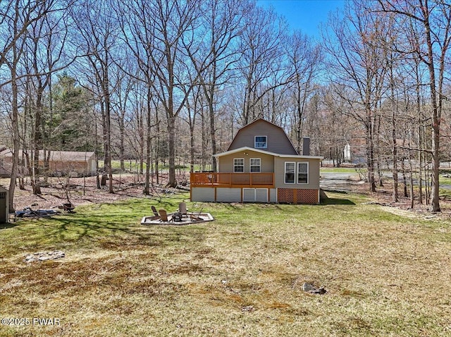 view of yard with a fire pit and a deck