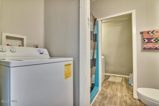laundry area with laundry area, washer / clothes dryer, and wood finished floors