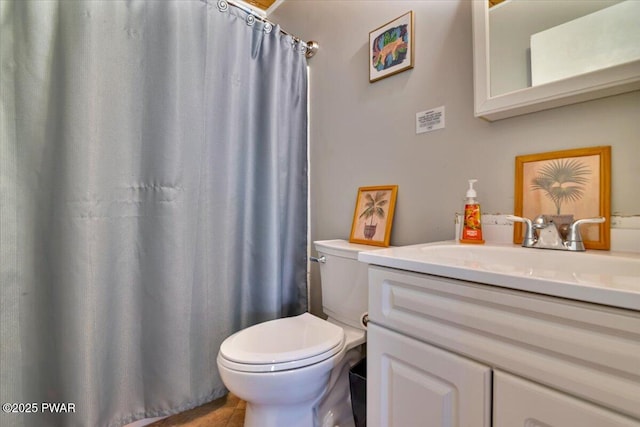 bathroom featuring toilet, a shower with curtain, and vanity