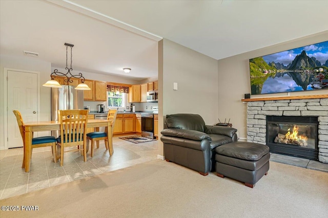 living room with light carpet and a fireplace
