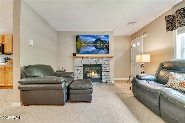 living room featuring carpet floors, baseboards, and a fireplace