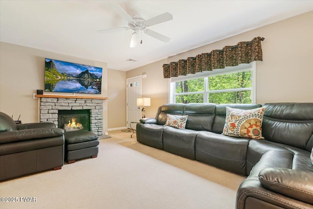 carpeted living area featuring a ceiling fan and a fireplace