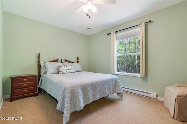 carpeted bedroom featuring a baseboard heating unit, baseboards, and a ceiling fan
