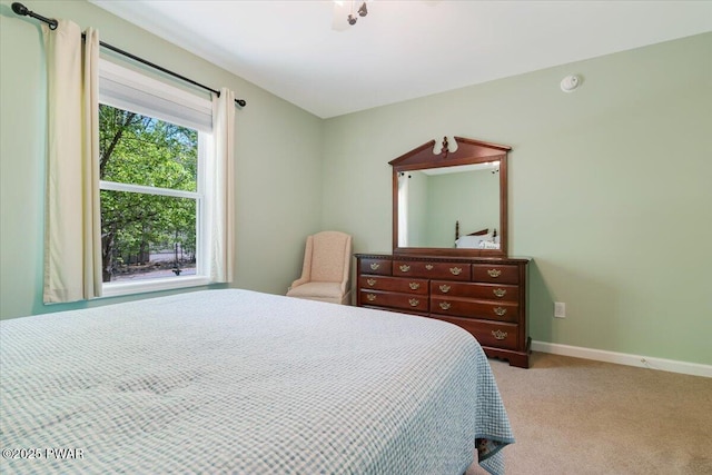 carpeted bedroom featuring baseboards