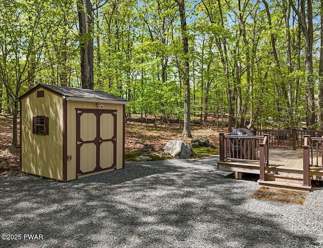 view of patio with a shed, an outbuilding, and a wooden deck