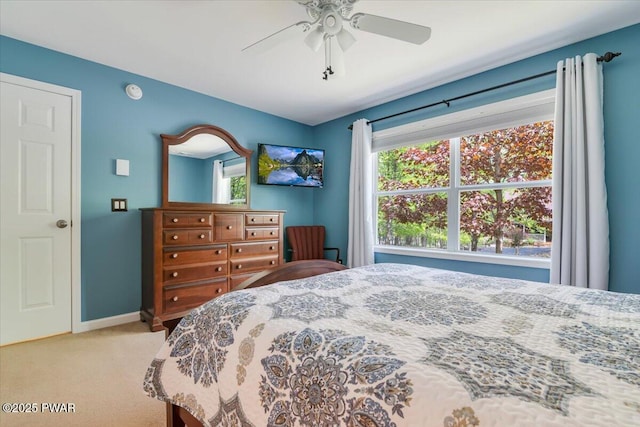 bedroom featuring carpet, baseboards, and a ceiling fan